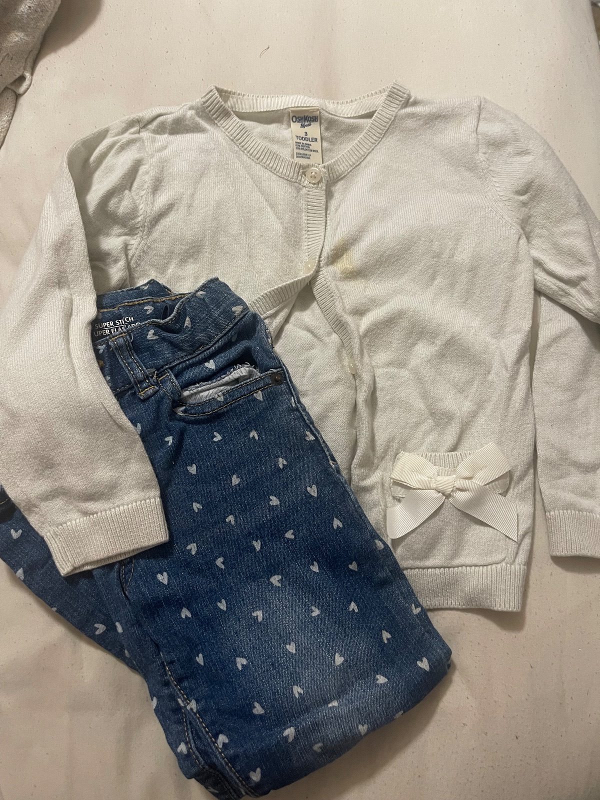 White cardigan w/ bows + heart stamped jeans
